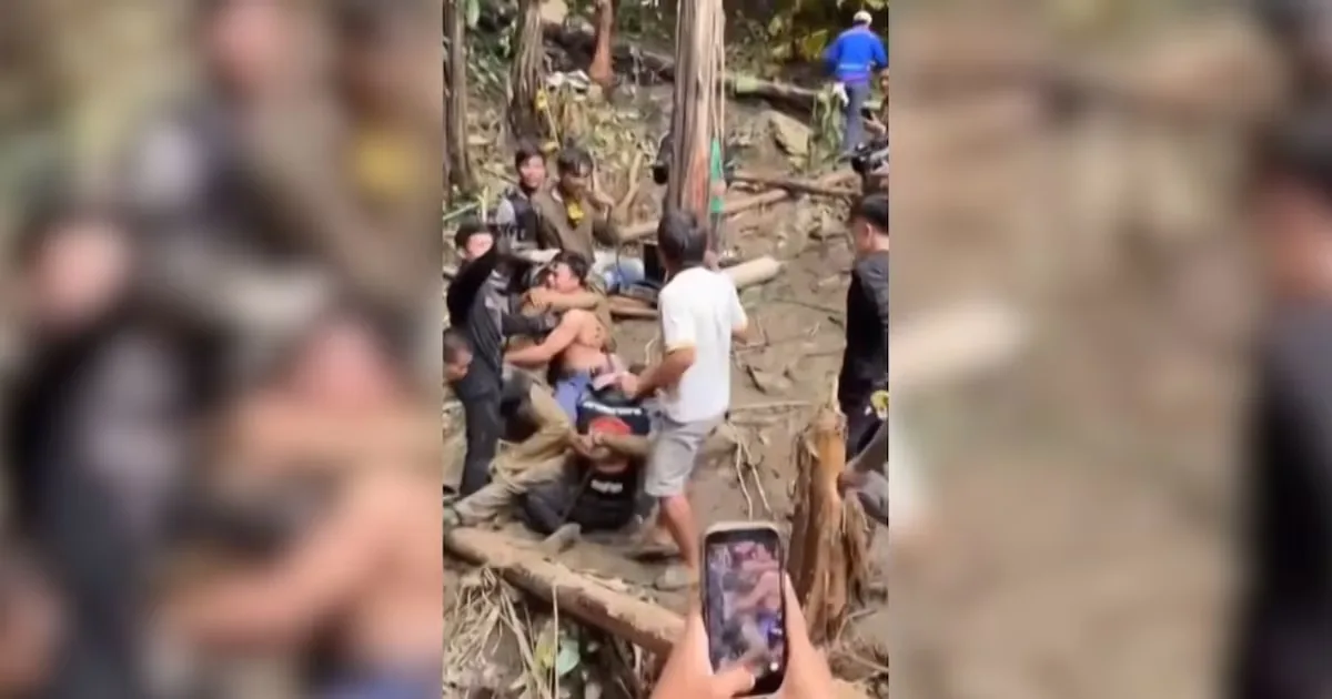 Heavy rains delay the search for the other two people trapped in a cave in Laos